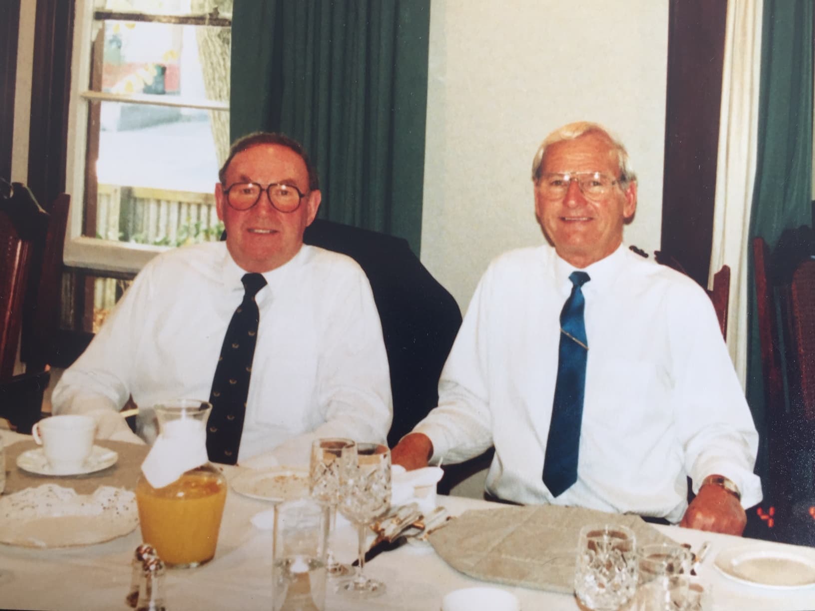 Two men, Dick Edwards and Des Hardy, sitting at a table.